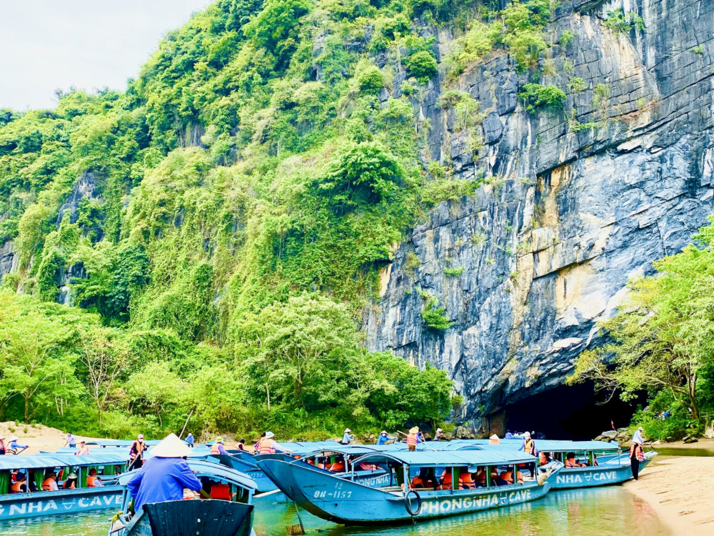 From the boat dock, travelers can either join a shared boat ride, then hike up to Tien Son Cave or arrange for a private tour